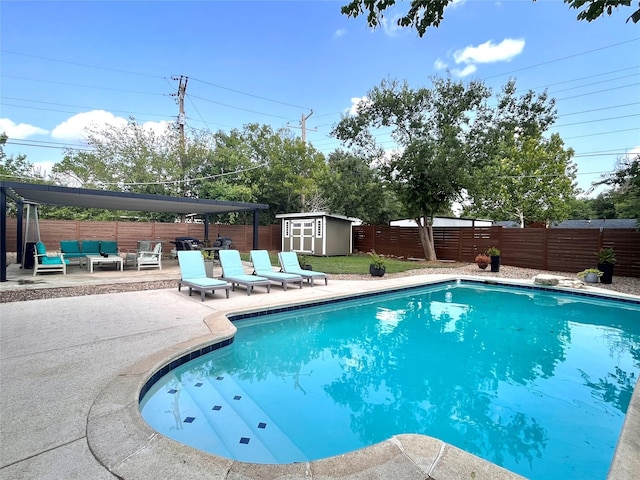 view of pool featuring a storage shed, a patio area, and outdoor lounge area