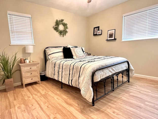 bedroom with ceiling fan and light wood-type flooring