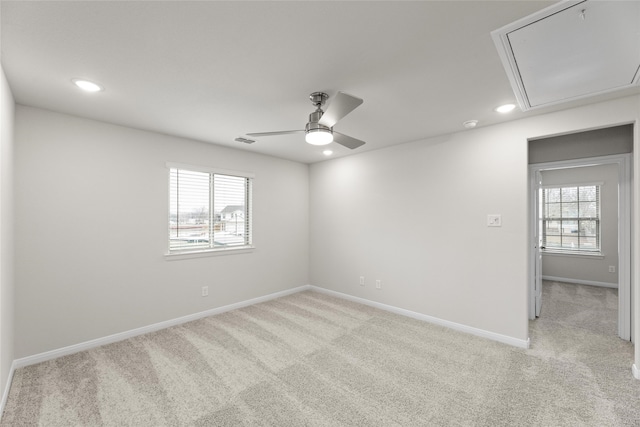 carpeted empty room with a healthy amount of sunlight and ceiling fan