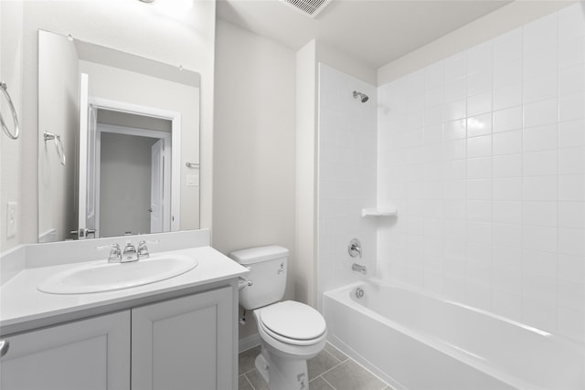 full bathroom with tile patterned flooring, vanity, tiled shower / bath combo, and toilet