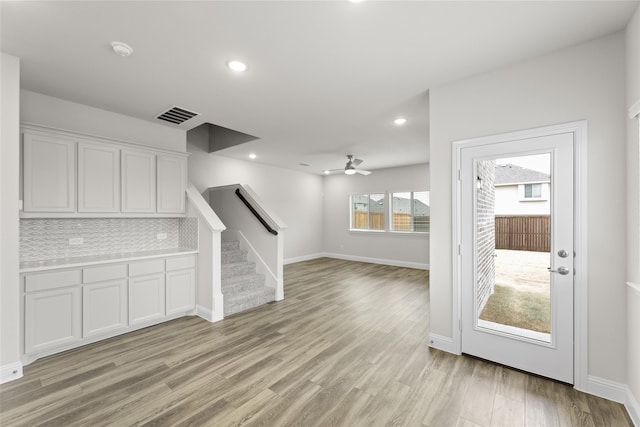 unfurnished living room featuring light hardwood / wood-style flooring and ceiling fan