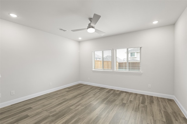 empty room featuring hardwood / wood-style floors and ceiling fan