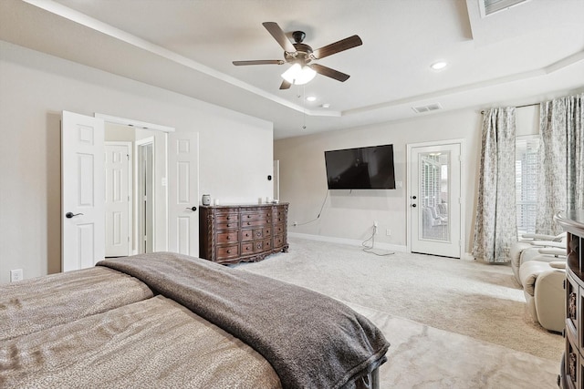 bedroom with access to outside, a raised ceiling, ceiling fan, and carpet flooring