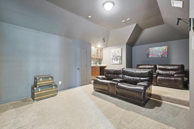 home theater with carpet flooring and vaulted ceiling