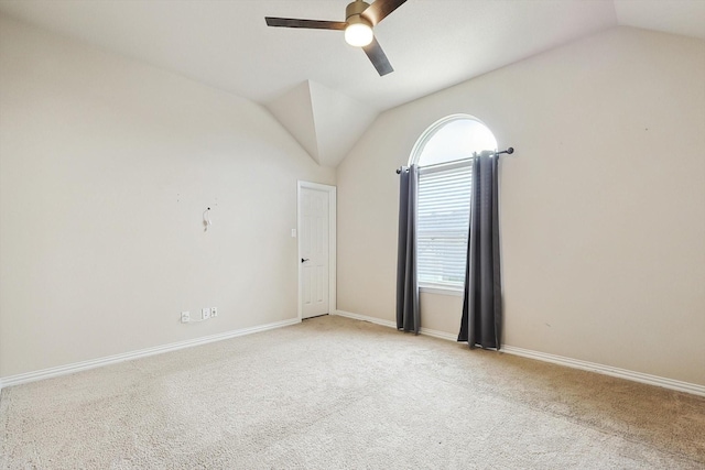 unfurnished room featuring ceiling fan, light colored carpet, and vaulted ceiling