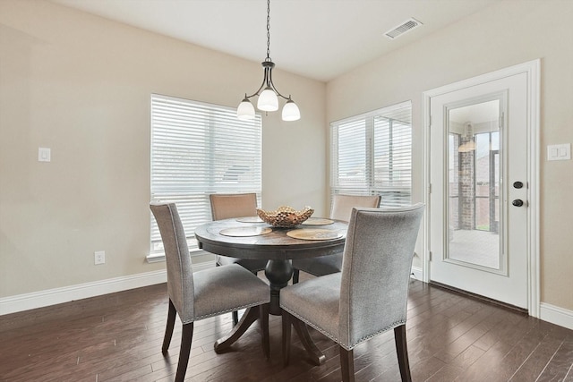 dining space featuring dark wood-type flooring