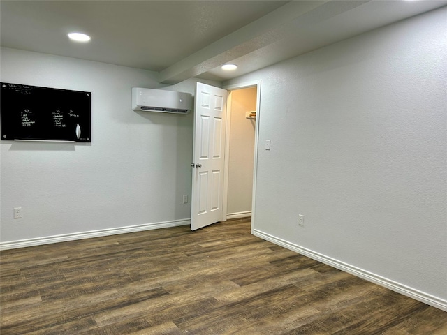 334 Fort Graham Rd, Whitney, TX 76692 - below grade area with a wall mounted AC, baseboards, dark wood-style flooring, and recessed lighting