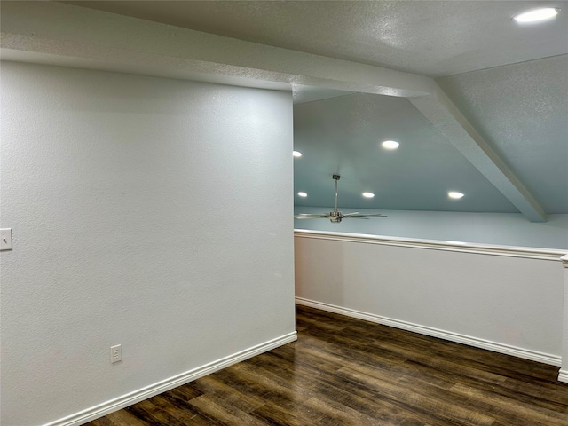 additional living space featuring vaulted ceiling with beams, ceiling fan, and hardwood / wood-style floors