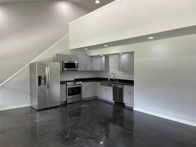 334 Fort Graham Rd, Whitney, TX 76692 - kitchen featuring appliances with stainless steel finishes, baseboards, dark countertops, a sink, and gray cabinetry