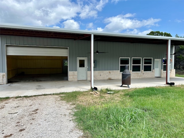 back of property featuring a garage and electric panel