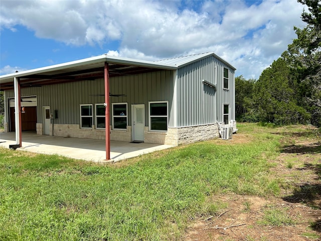 rear view of property with a lawn and a carport