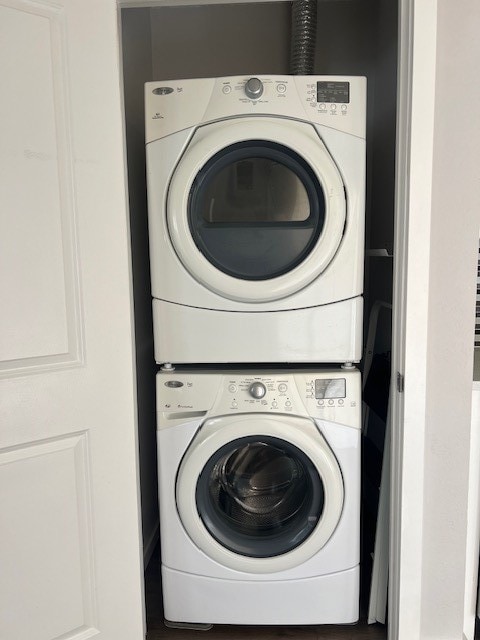 clothes washing area featuring stacked washer / dryer