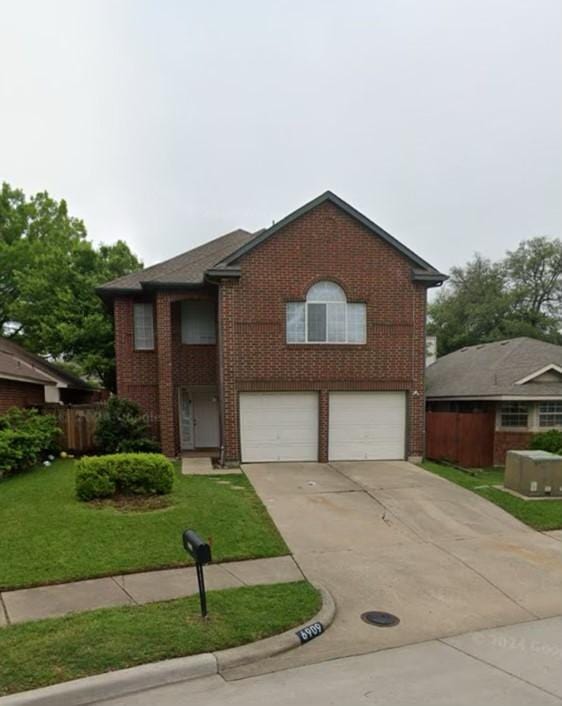 view of front of home with a garage and a front yard