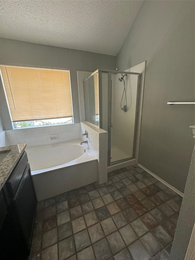 bathroom featuring vanity, a textured ceiling, and independent shower and bath