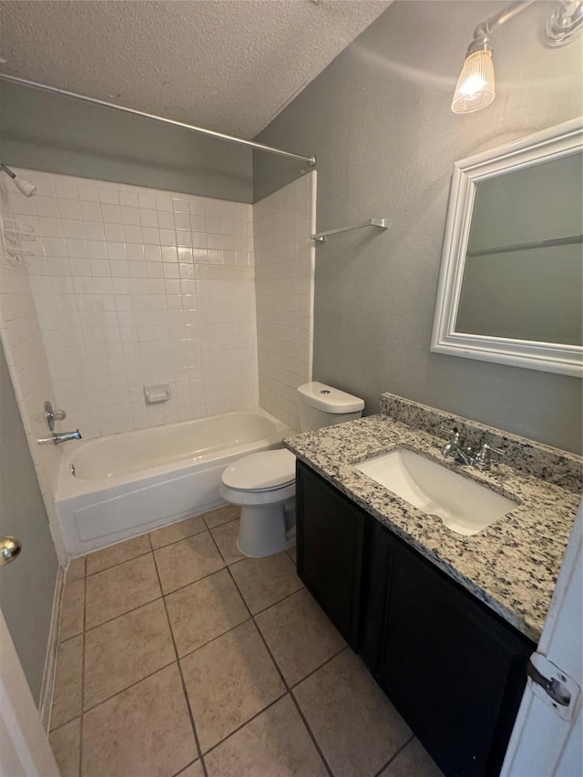 full bathroom with vanity, tile patterned floors, toilet, a textured ceiling, and shower / bath combination