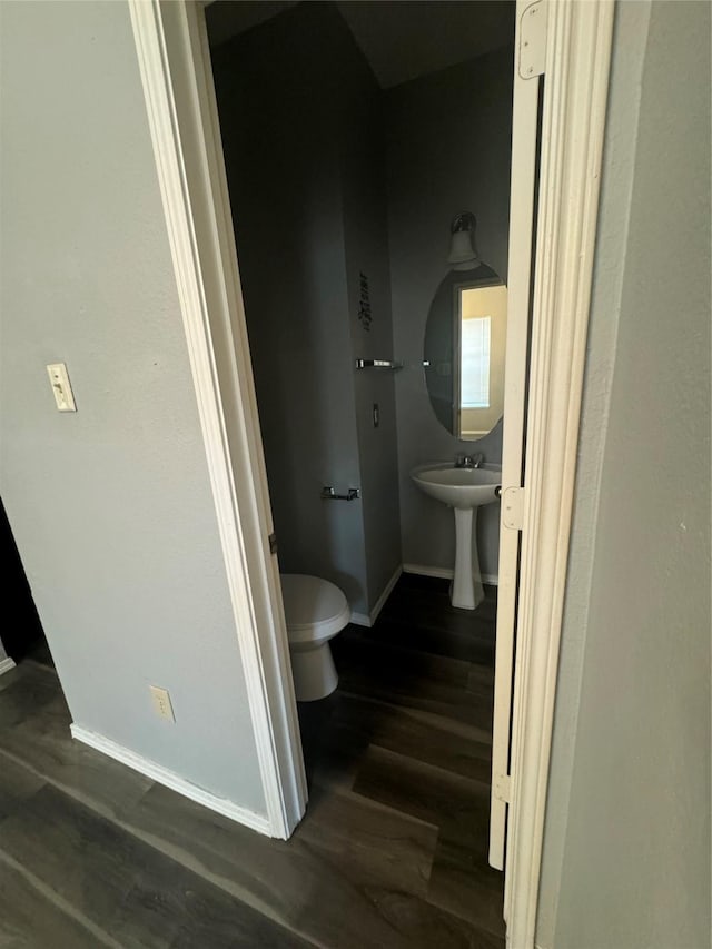 bathroom with wood-type flooring and toilet