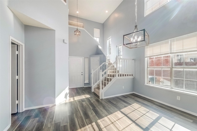 entrance foyer with a chandelier, a high ceiling, and dark hardwood / wood-style floors