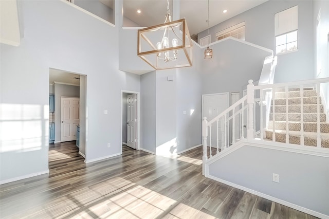 foyer entrance with a chandelier, a high ceiling, and hardwood / wood-style flooring