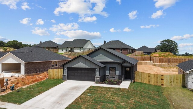 view of front of house featuring a front yard and a garage