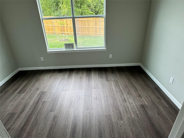 spare room with dark hardwood / wood-style flooring