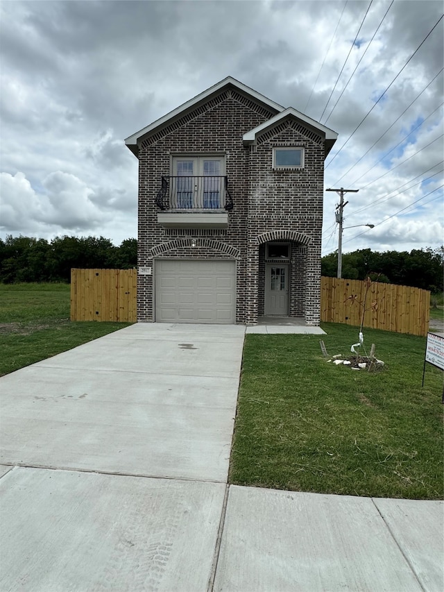 front of property with a garage, a balcony, and a front lawn