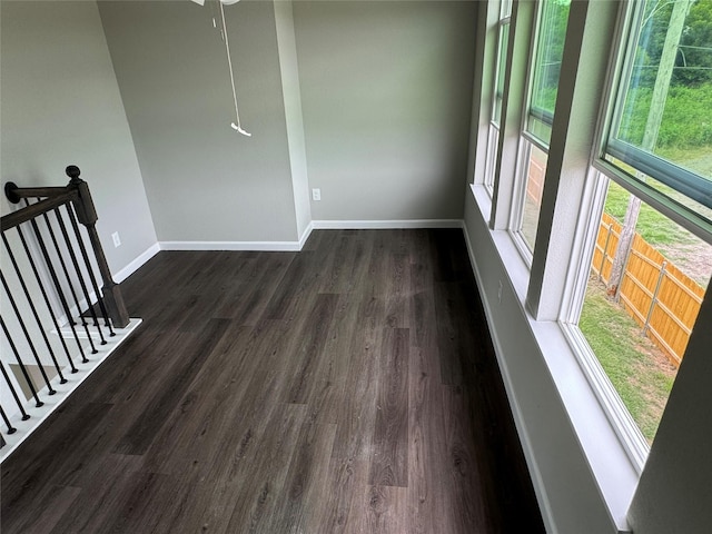 unfurnished room featuring dark wood-type flooring