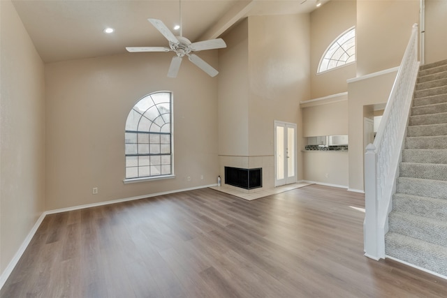 unfurnished living room featuring ceiling fan, light hardwood / wood-style flooring, and a wealth of natural light