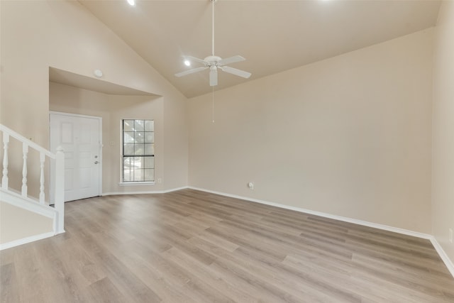 empty room featuring ceiling fan, light hardwood / wood-style floors, and high vaulted ceiling