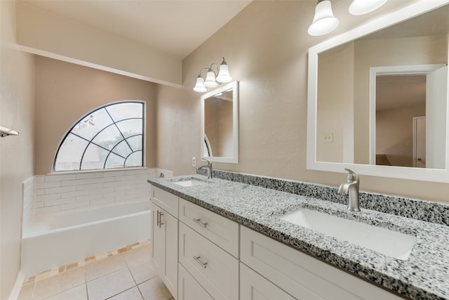 bathroom with tile patterned flooring, a bath, and double vanity