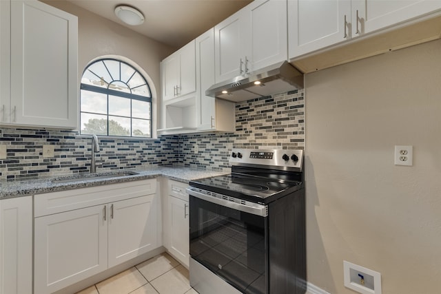 kitchen featuring stainless steel electric range, white cabinets, sink, backsplash, and light tile patterned floors