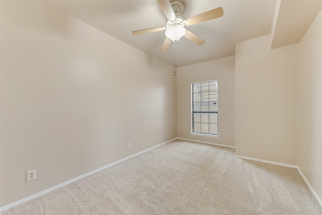 spare room featuring light colored carpet and ceiling fan