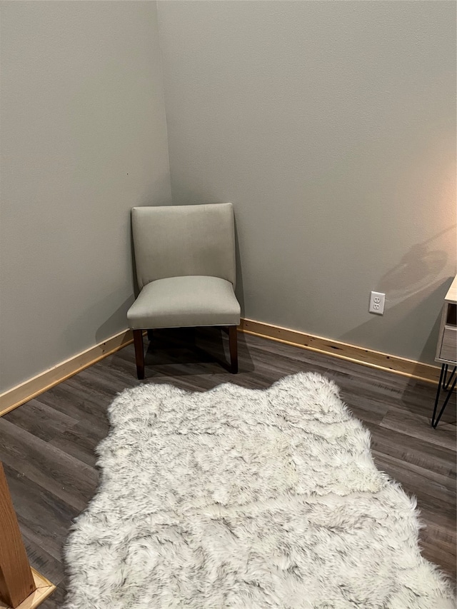 sitting room with dark hardwood / wood-style flooring