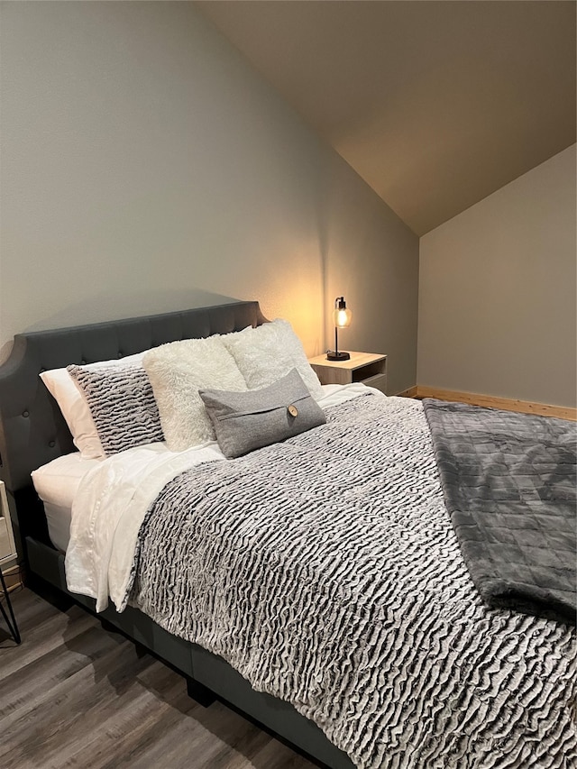 bedroom featuring lofted ceiling and hardwood / wood-style flooring