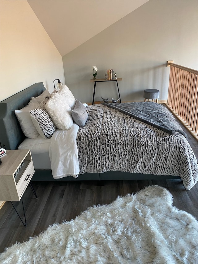 bedroom with dark wood-type flooring and vaulted ceiling