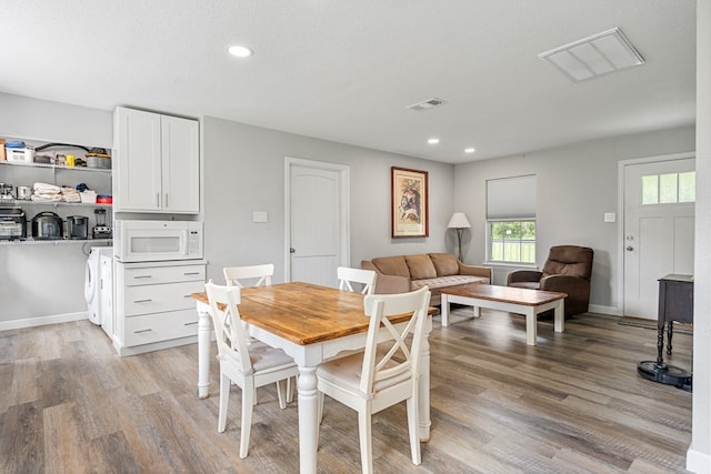 dining area featuring light wood-type flooring