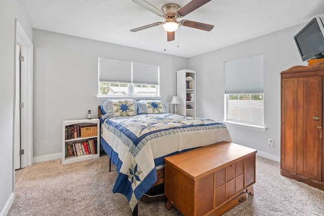 bedroom featuring carpet flooring, ceiling fan, a textured ceiling, and baseboards