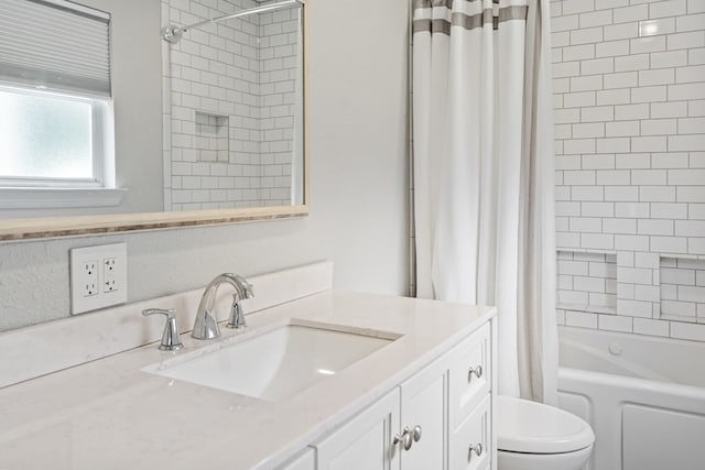 full bathroom with vanity, shower / bath combo, and toilet