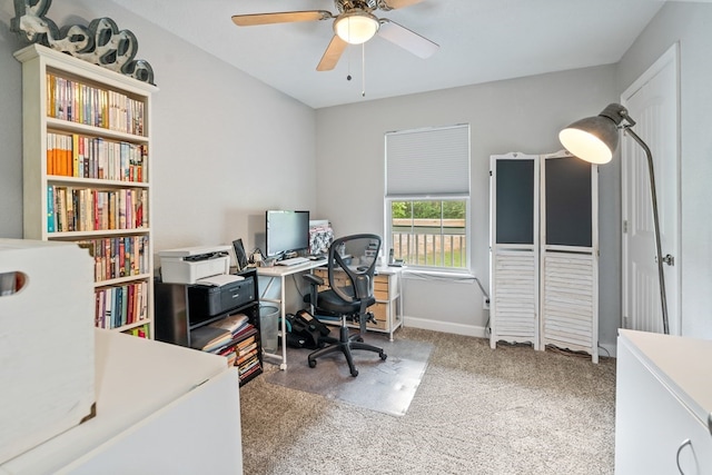 carpeted home office featuring ceiling fan