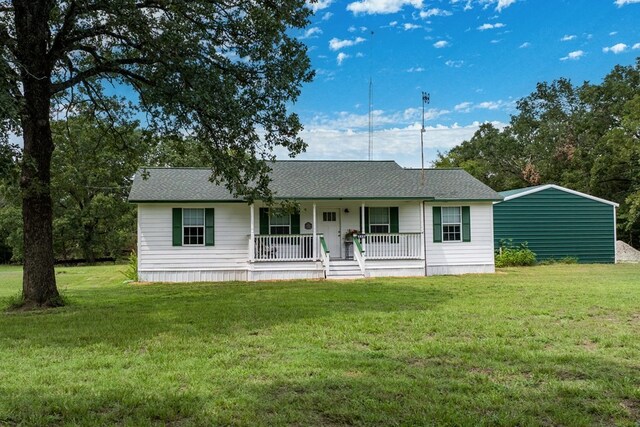 single story home featuring covered porch and a front lawn