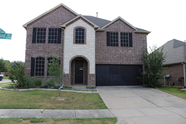 view of front facade with a garage and a front lawn