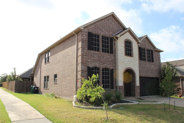 view of front of property featuring a garage and a front yard