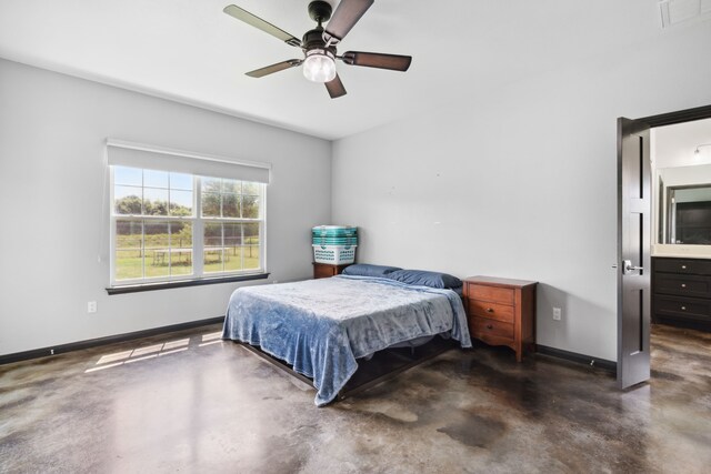 bedroom with concrete flooring, connected bathroom, and ceiling fan