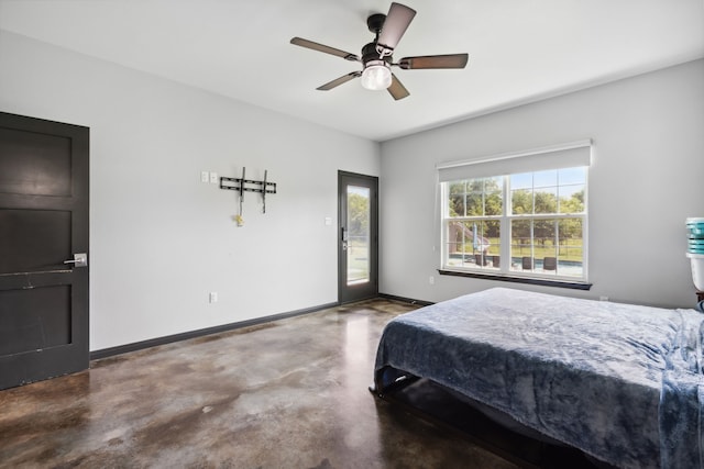 bedroom with access to exterior, concrete flooring, and ceiling fan