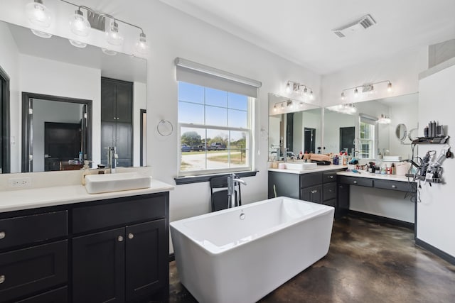 bathroom with concrete floors, dual bowl vanity, and a bathtub