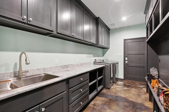 laundry room featuring sink, separate washer and dryer, and cabinets