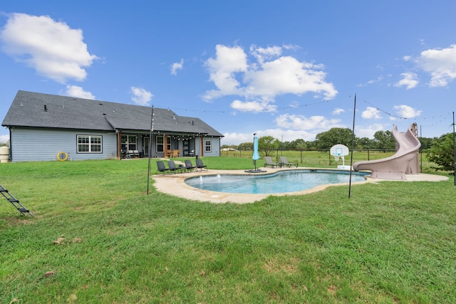 view of pool featuring a water slide and a yard