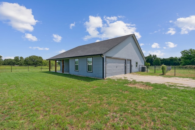 view of side of property featuring a garage and a yard