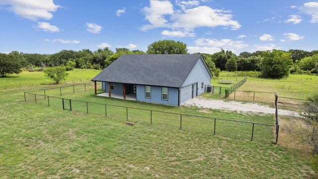 view of front of home with a rural view and a front yard