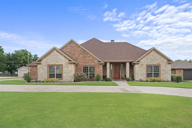 view of front of house featuring a garage and a front lawn