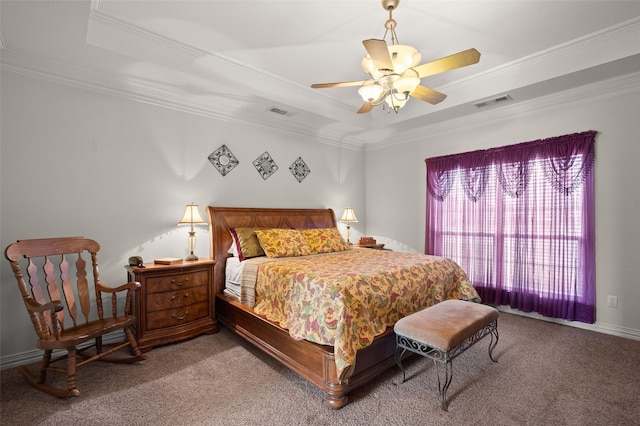 carpeted bedroom with ornamental molding, a raised ceiling, and visible vents